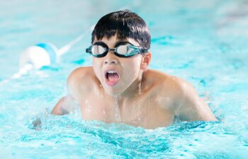 kid swimming in the pool after visiting dentist new braunfels